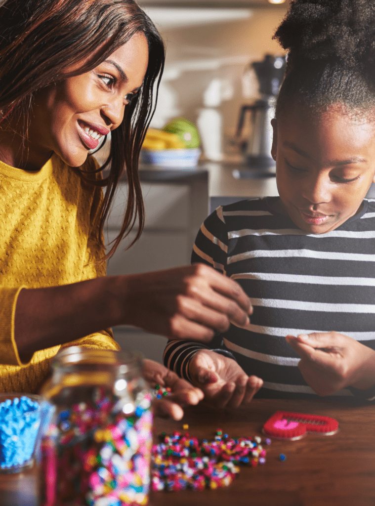 Mother and daughter working on a school project at the kitchen table