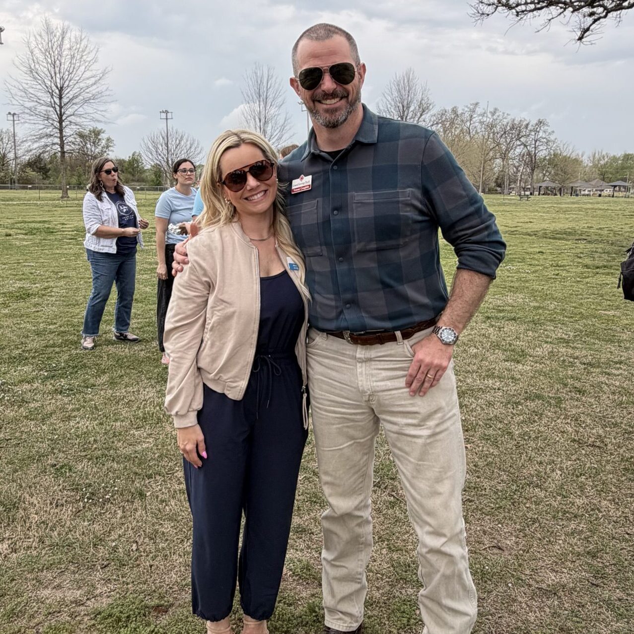 CFAC board members pose together outdoors at a Child Abuse Prevention Month awareness event in a grassy park setting.